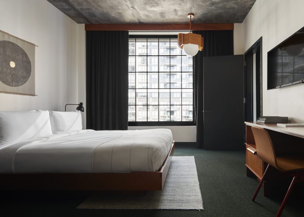 A dedicated bedroom provides a desk for work and window with city views